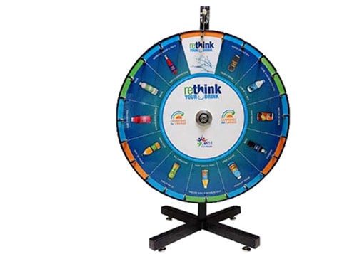 A prizewheel with the words, 'Rethink your drink' in the center, featuring various bottled drinks in between the spokes.