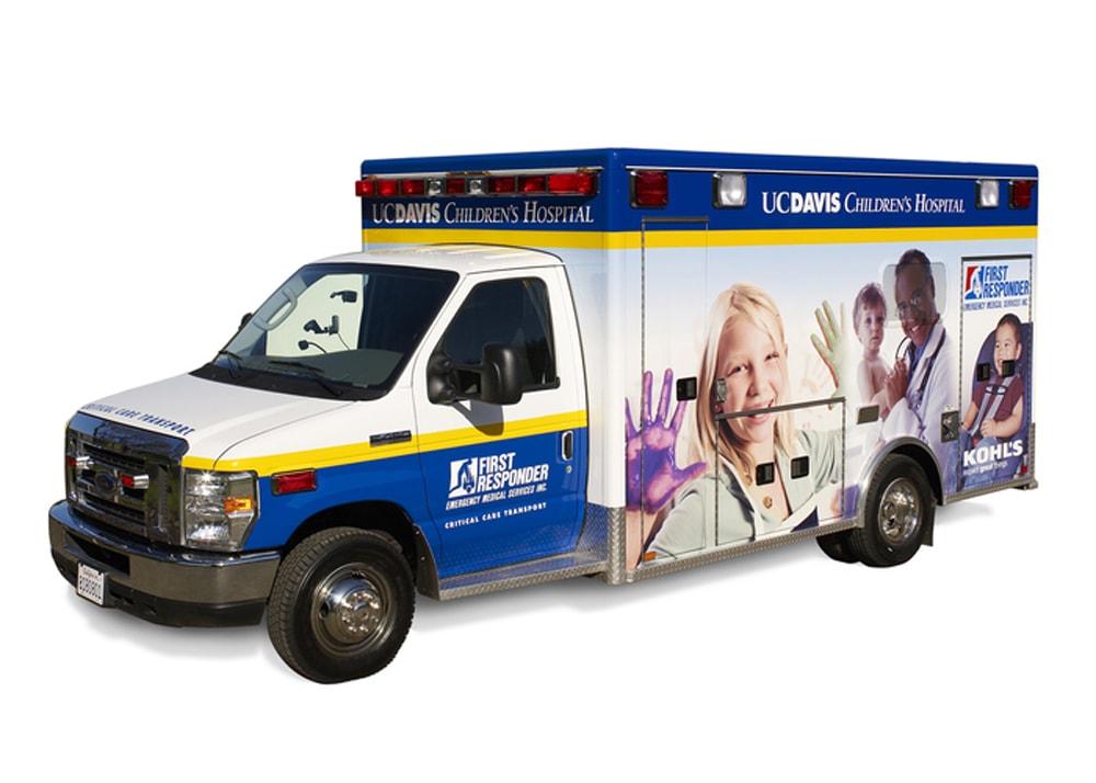 First responder vehicle covered with the UC Davis Children's Hospital vehicle wrap, featuring images of kids and a doctor.