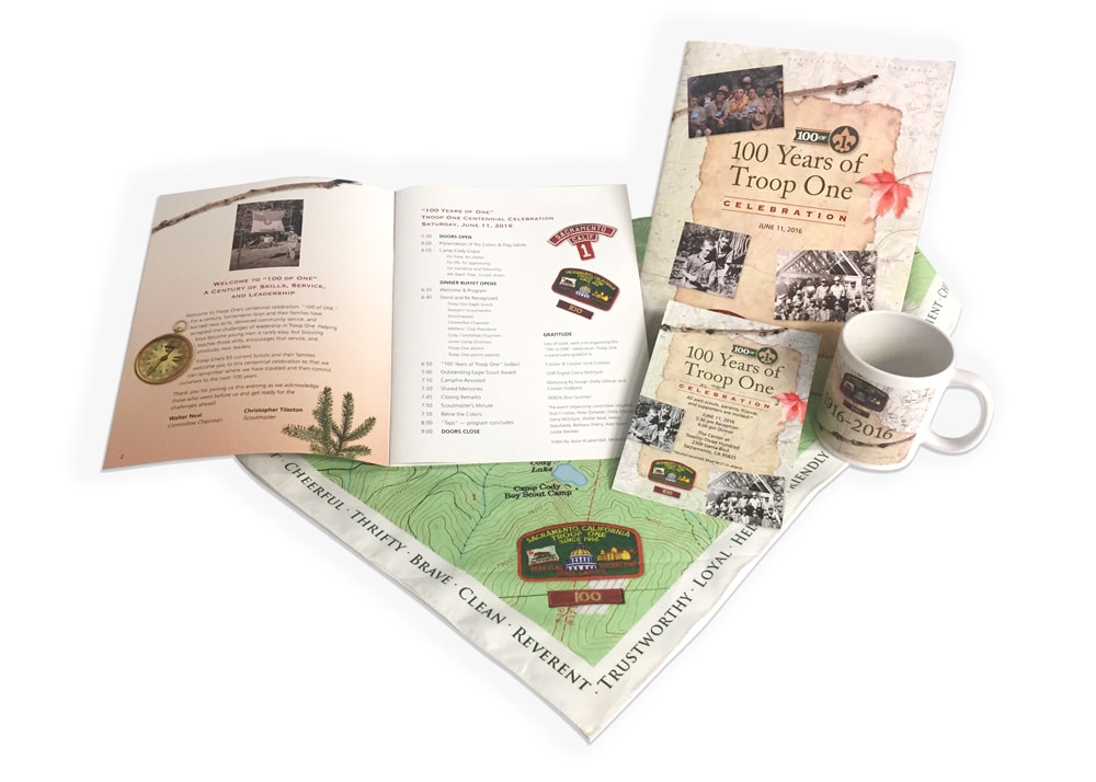 Various examples of print design on different types of media for boy Scouts Troop 1 of Sacramento, including brochures, a mug, and a bandana.